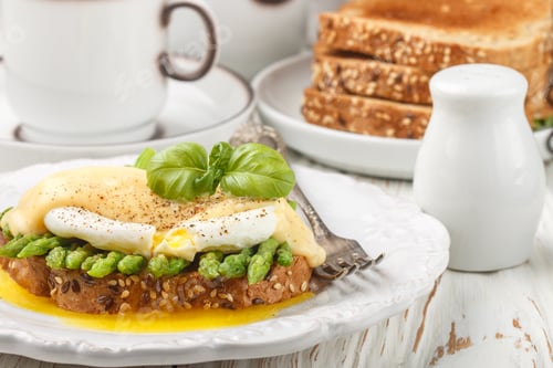 Preview: Bread Toast With Sesame And Flax Seed, Asparagus, Poached Egg And Hollandaise Sauce. A Traditional