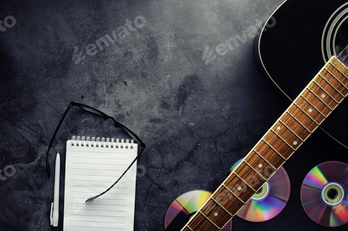 Preview: Guitar And Accessories On A Stone Background. Desk Musician, Headphones, Microphone And More.