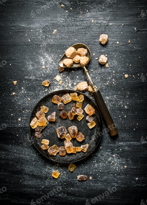 Preview: Brown Cane Sugar. On A Black Rustic Background.