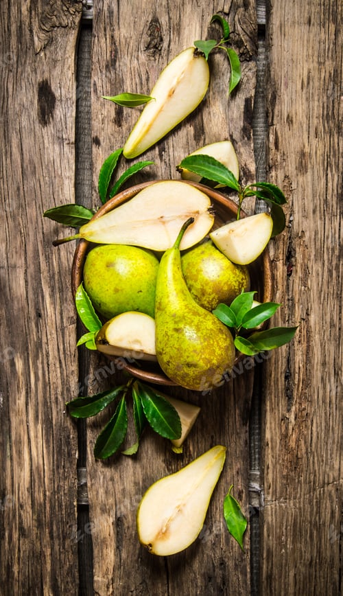 Preview: Pears With Leaves In The Basket. On The Wooden Background. Top View