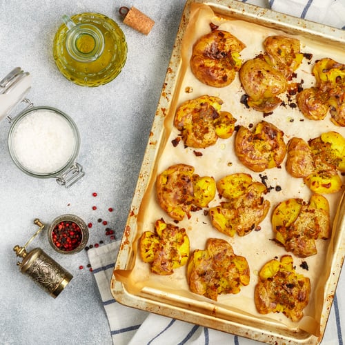 Preview: Oven Baked Whole Crushed And Crusty Potato With Coarse Sea Salt, Olive Oil, Garlic, Pepper And