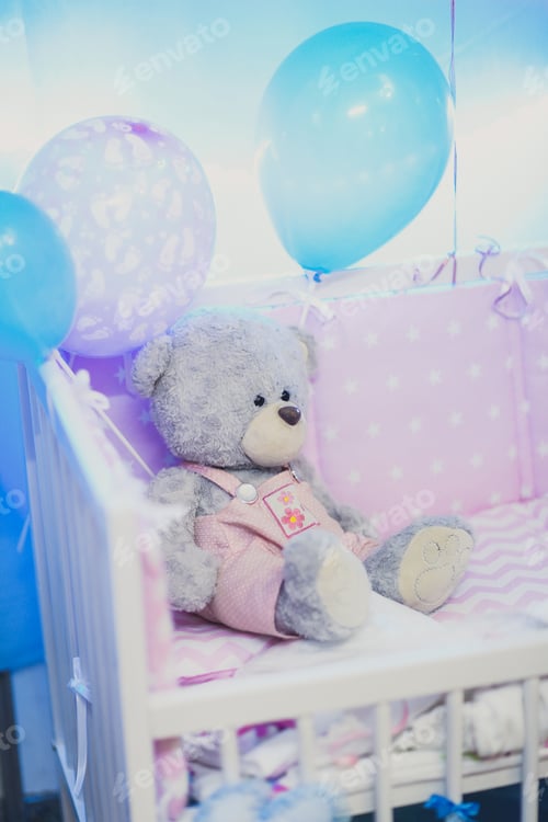 Preview: Toy Bear Sitting In The Cot In Pink Shades Of Blue Colors. Happy Toy For Newborn Kids Or Babies