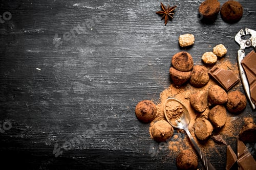 Preview: Chocolate Truffles With Cocoa And Cinnamon. On A Black Wooden Background.