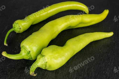 Preview: Group Of Three Whole Hot Green Pepper Banana On Grey Stone