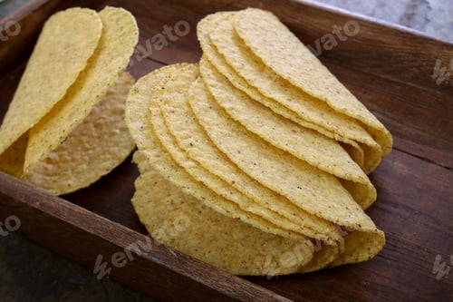 Pile of Empty Taco Shells on Wood