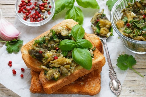 Preview: Baked Eggplant On Bread Croutons With Garlic, Cilantro And Basil. Spicy Snack. Selective Focus