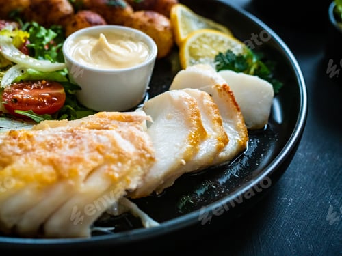 Preview: Fish Dish - Fried Cod Fillet With Potatoes And Vegetable Salad On Black Wooden Table