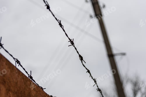 Preview: Barbed Wire Against Sky On Cloudy Day