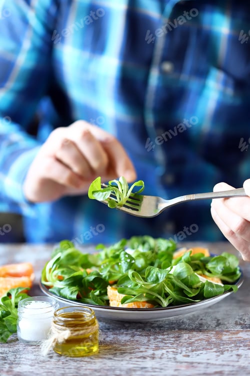 Preview: Chef Preparing A Healthy Salad. Male Hand Mixed Salad With Mozzarella And Tangerine. Salad A La