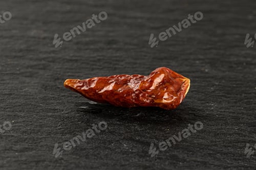 Preview: One Whole Dry Red Chili Pepper Peperoncino On Grey Stone