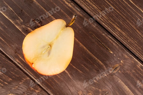 Preview: One Half Of Fresh Red Pear Flatlay On Brown Wood