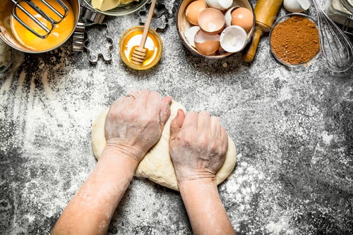 Preview: Dough Background. Woman Kneads Dough With Various Ingredients On The Table. On Rustic Background .