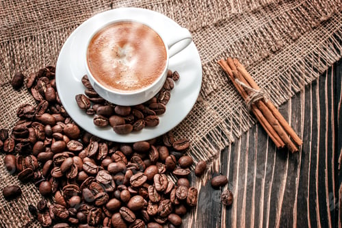 Preview: Cup Of Coffee And Coffee Grains On An Old Wooden Board