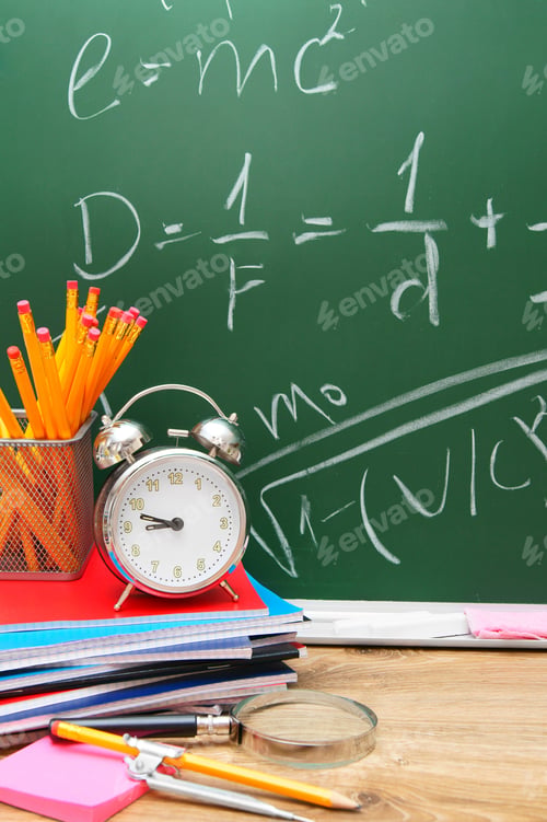 Preview: Alarm Clocks And School Accessories Against A School Board.