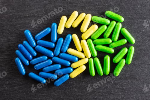 Preview: Lot Of Whole Blue Yellow And Green Sweet Licorice Comfit Flatlay On Grey Stone