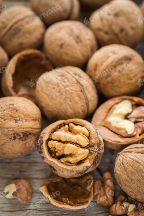 Preview: Walnut Kernels And Whole Walnuts On Rustic Old Wooden Table. Soft Focus