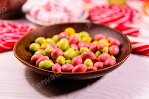 Preview: Ceramic Plate With Colored Candies, Candy Cane, Lollipops And Marshmallows On Wooden Table