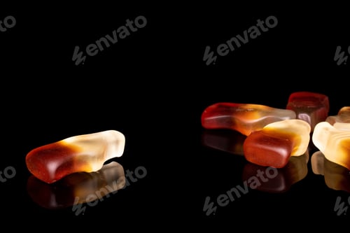 Preview: Group Of Six Whole Arranged Sweet Jelly Cola Isolated On Black Glass
