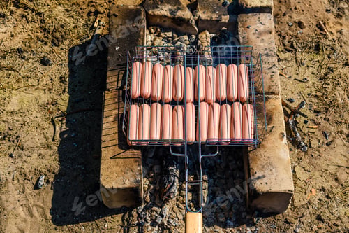 Preview: Sausages Cooking In Barbecue Grill On Campfire