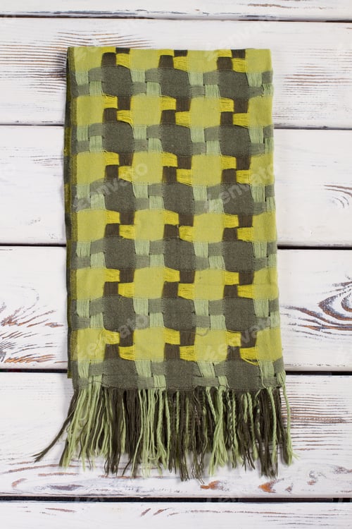 Preview: Beautiful Green Scarf On A Wooden Background. Warm Wool Winter Scarf.