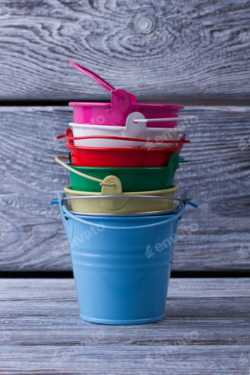 Preview: Stack Of Multi-Colored Buckets On The Wooden Background. Objects For The Interior.