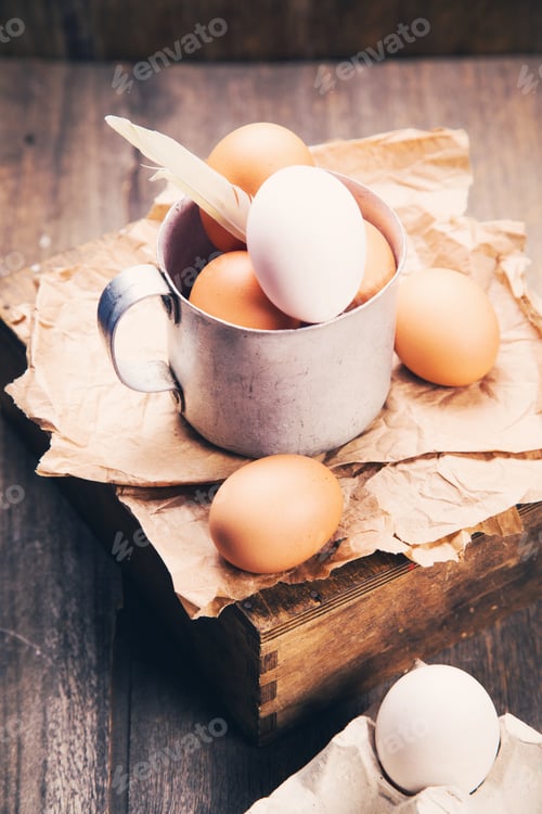 Preview: Some Fresh Brown And White Eggs In Old Cup In Studio