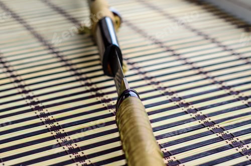 Preview: Japanese Sword Katana On A Bamboo Mat. Selective Focus