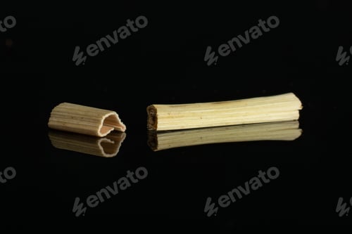 Preview: Group Of Two Pieces Of Lemon Grass Of Lingonberry Strawberry Fruit Tea Macro Isolated On Black Glass