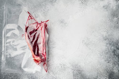 Preview: Fresh Marbled Meat Black Angus Steak In Vacuum Plastic Bag For Sous Vide Set, On Gray Stone