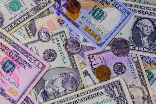 Preview: Different American Cent Coins Over Dollar Banknotes