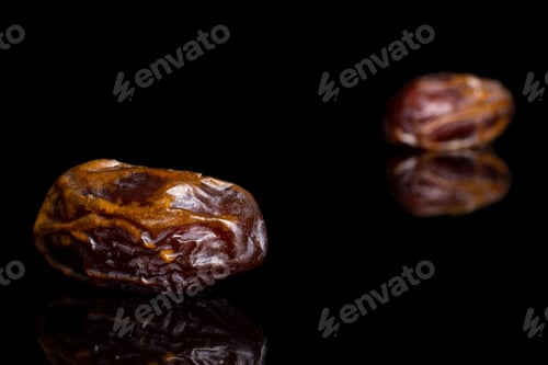 Preview: Group Of Two Whole Dry Brown Date Fruit Isolated On Black Glass