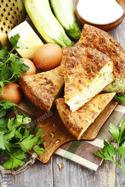 Preview: Pie With Zucchini, Cheese And Herbs On The Table