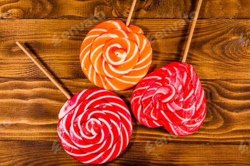 Preview: Big Sweet Lollipops On Rustic Wooden Table. Top View