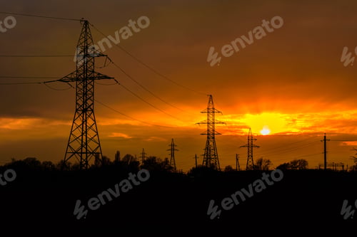 Preview: High Voltage Power Line At Sunset. Silhouettes Of Metal Pillars