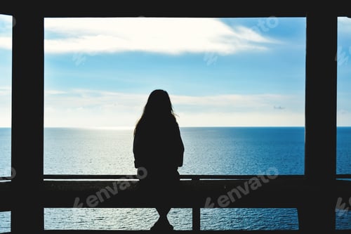 Preview: Silhouette Of Women Sitting And Look The Sea During Sunset