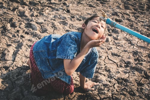Preview: Sad Children Want To Drink Some Water On Crack Ground , Concept Drought And Shortage Of Water Crisis