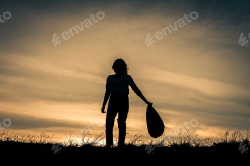Preview: Silhouette Woman Holding Plastic Bag Volunteer To Keeping The Garbage In The Nature