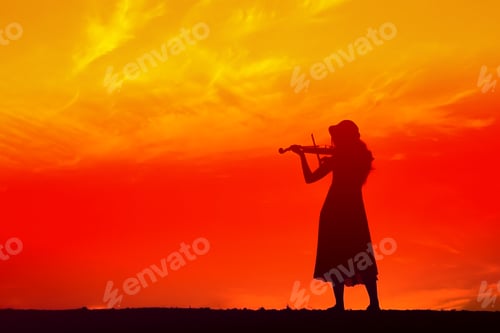Preview: Silhouette Women Play Violin Sunset Background.Warm Tone