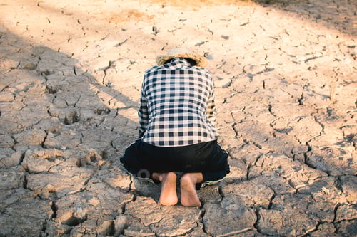 Preview: Asian Man On Cracked Dry Ground, Concept Drought And Crisis Environment
