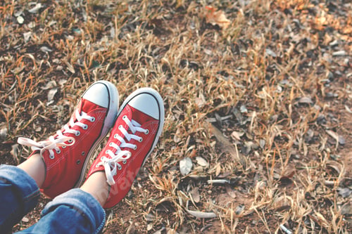 Preview: Feet Red Sneaker A Girl In Nature And Relax Time On Holiday. Selective And Soft Focus Color Of