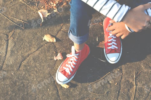 Preview: Feet Red Sneaker A Girl In Nature And Relax Time On Holiday. Selective And Soft Focus Color Of