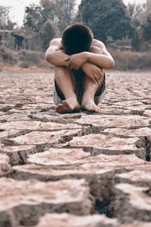 Preview: Sad Boy Sitting On Dry Ground