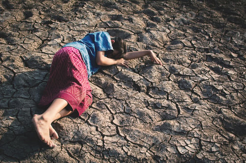 Preview: Sad Girl Tired And Exhausted On Cracked Dry Ground , Concept Drought And Shortage Of Water Crisis