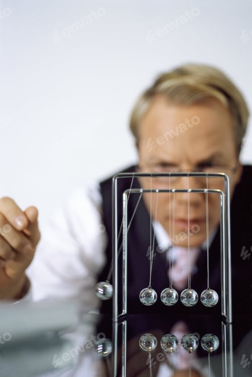Preview: View Of Businessman Playing With Pendulum
