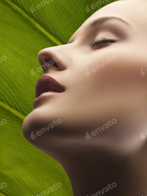 Preview: Close-Up Portrait Of Young Woman With Eyes Closed, Leaf Background