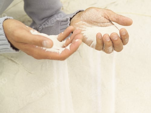 Preview: Close Up Of Sand Pouring Through Man’S Hands