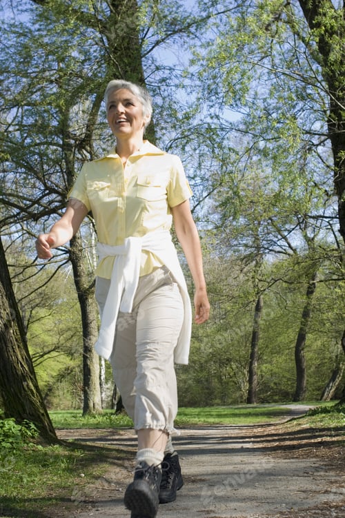 Preview: Low Angle View Of Senior Woman Walking In Park