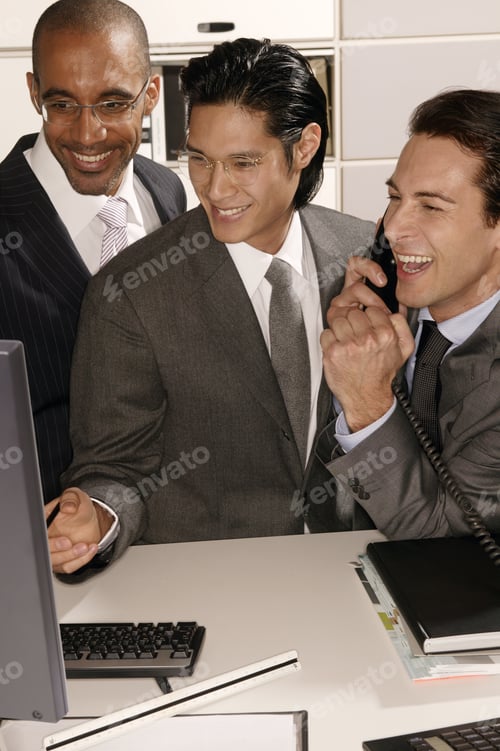 Preview: Three Businessmen Looking At A Computer Laughing