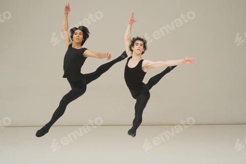 Preview: Two Young Male Ballet Dancers Leaping In The Air