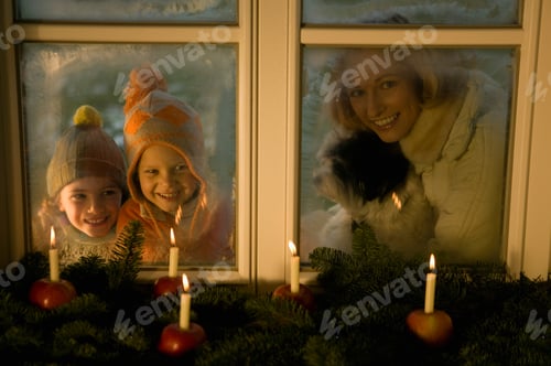 Preview: People Looking At Christmas Decorations Of Candles In Apples Near Window